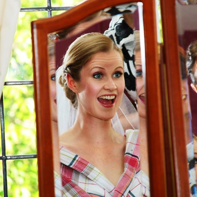 Mirror reflection of happy bride