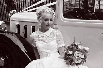 Bride sat near wedding car