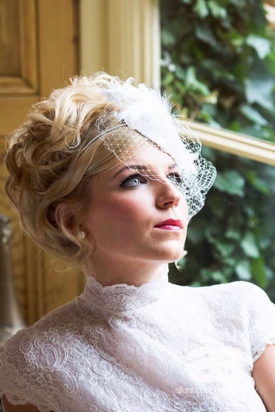 Vintage style bride looking out of window, hair and makeup 