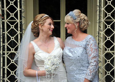 Bride with mother looking happily at each other